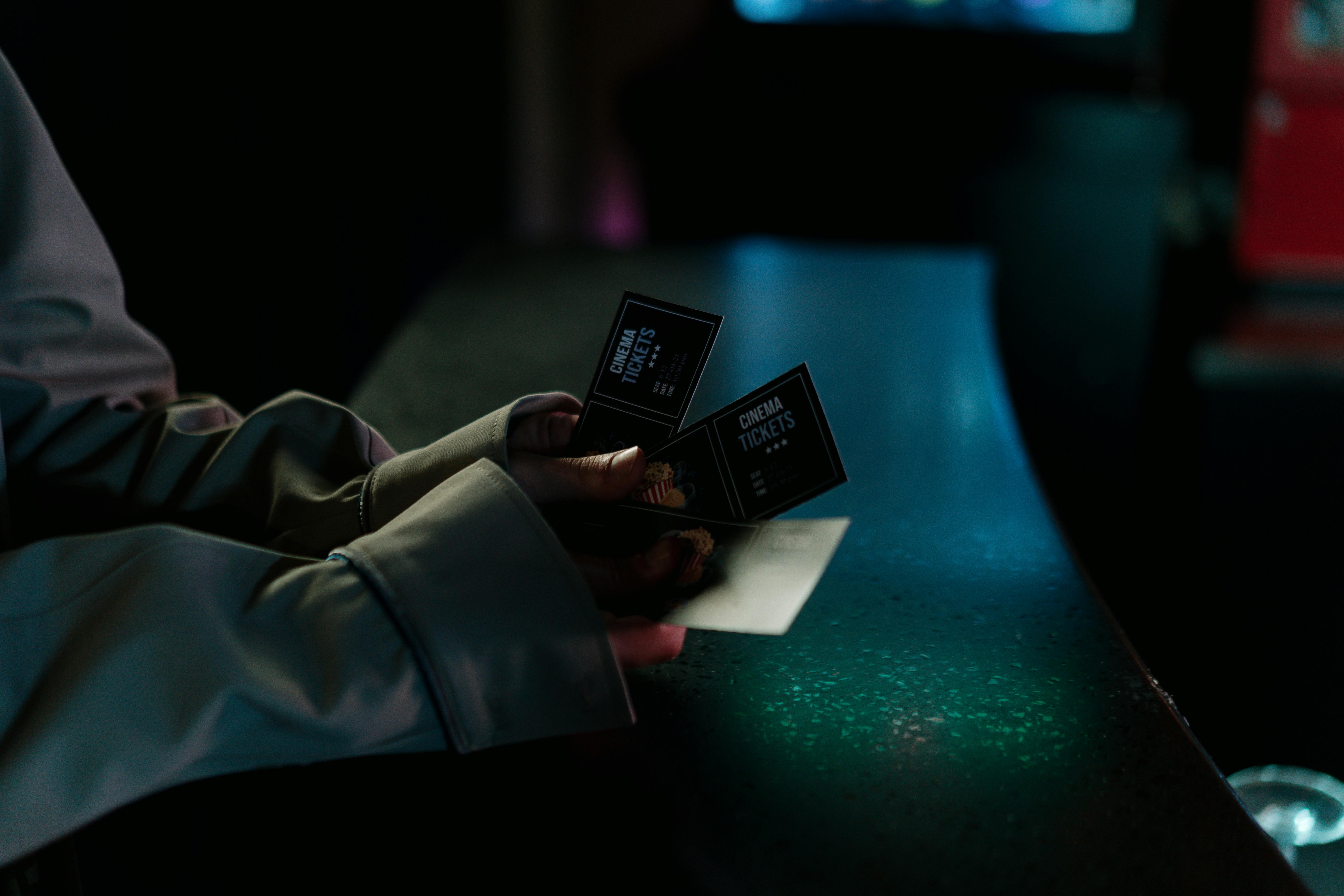 Hand grabbing movie tickets